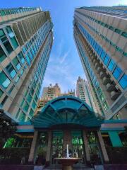 Tall modern skyscrapers with blue windows and central entrance