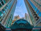 Tall modern skyscrapers with blue windows and central entrance