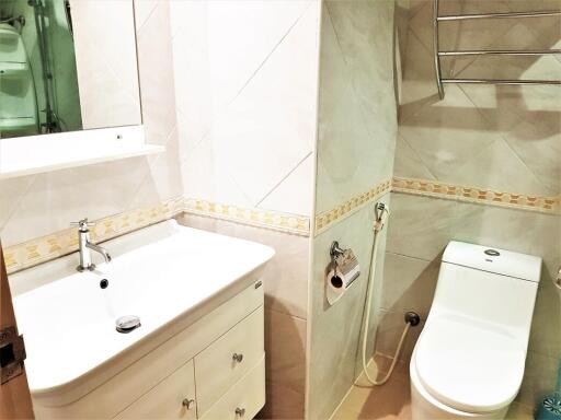 Modern bathroom with sink, vanity, and toilet