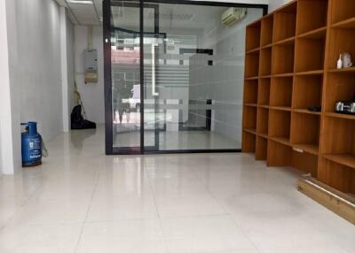 Empty office space with shelves and glass partition