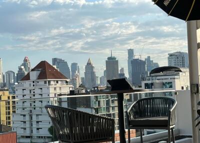 City view from a balcony with outdoor furniture