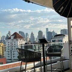 City view from a balcony with outdoor furniture