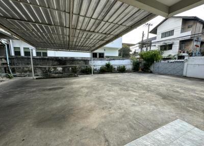 spacious covered outdoor area with paved ground