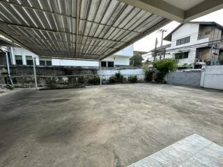 spacious covered outdoor area with paved ground