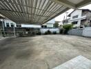 spacious covered outdoor area with paved ground