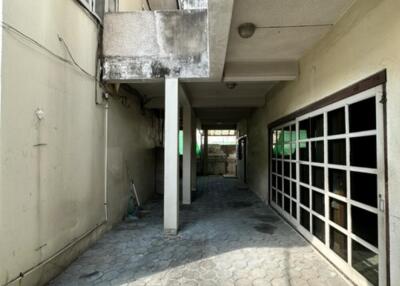 Covered outdoor space with tiled flooring and large garage door