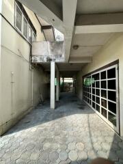 Covered outdoor space with tiled flooring and large garage door