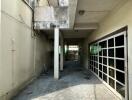 Covered outdoor space with tiled flooring and large garage door