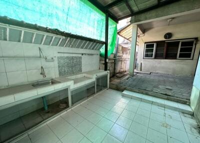 Outdoor kitchen area with sinks and tiled flooring