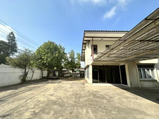 Exterior view of a two-story building with a large driveway