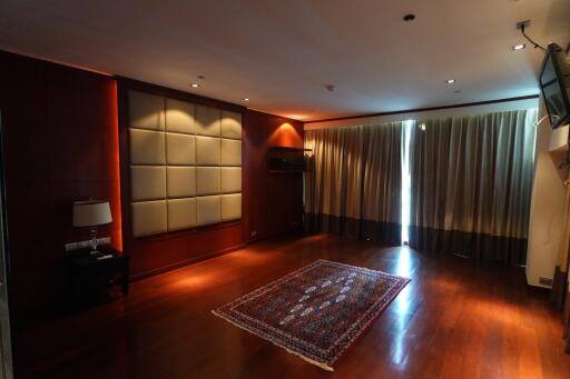 Spacious living room with wooden flooring and large windows