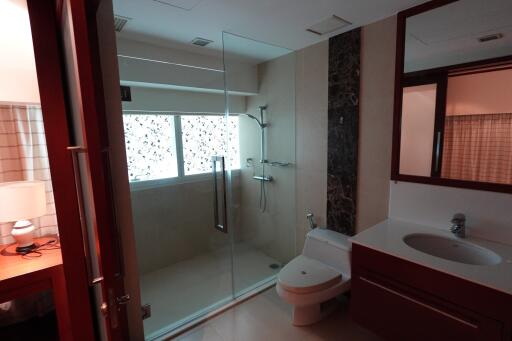 Modern bathroom with glass shower enclosure and single sink vanity