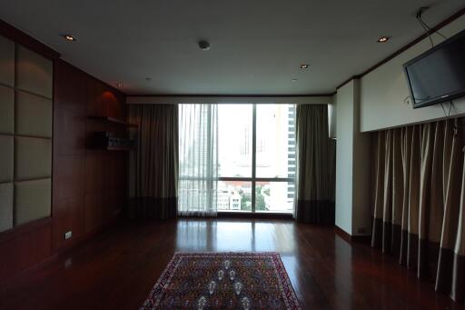 Spacious living room with wooden flooring and a large window