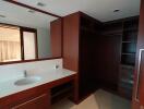 Modern bathroom with dark wood cabinetry and large mirror