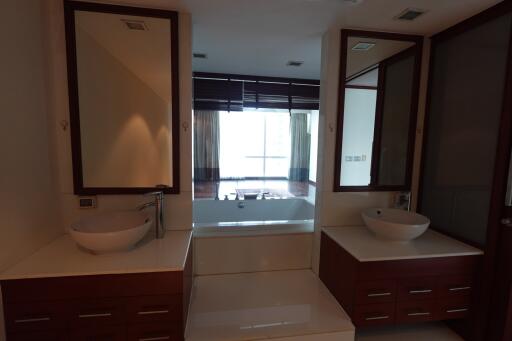 Modern bathroom with double sinks and a bathtub