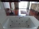 Bathroom with Jacuzzi and a view of the bedroom