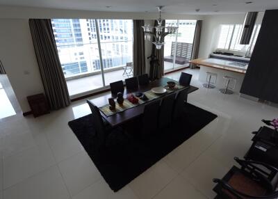 Modern dining area with large windows and city view