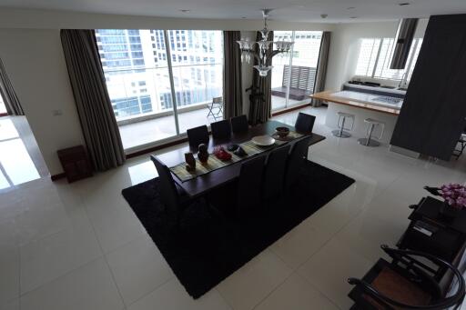 Modern dining area with large windows and city view