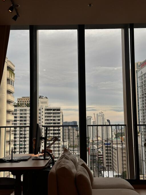 Living room with large windows and city view