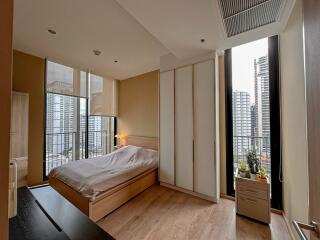 Modern bedroom with large windows and city view