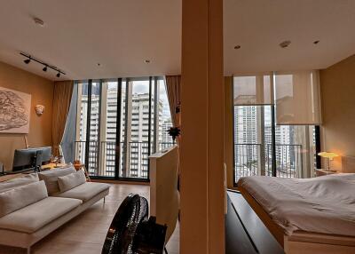 Modern living room and bedroom with large windows and city view