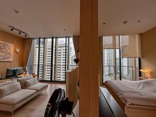 Modern living room and bedroom with large windows and city view