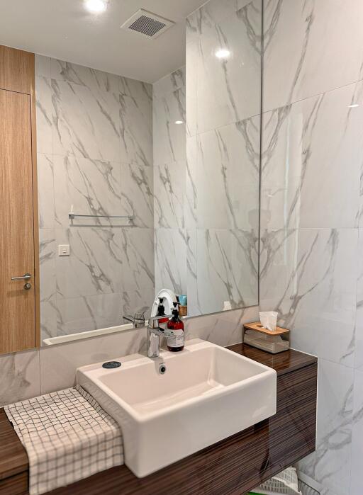 Modern bathroom with large marble tiles and a stylish sink