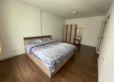 Spacious bedroom with double bed and wooden flooring