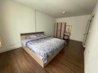 Spacious bedroom with double bed and wooden flooring