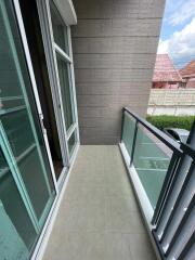 Small balcony with glass railing and tiled floor