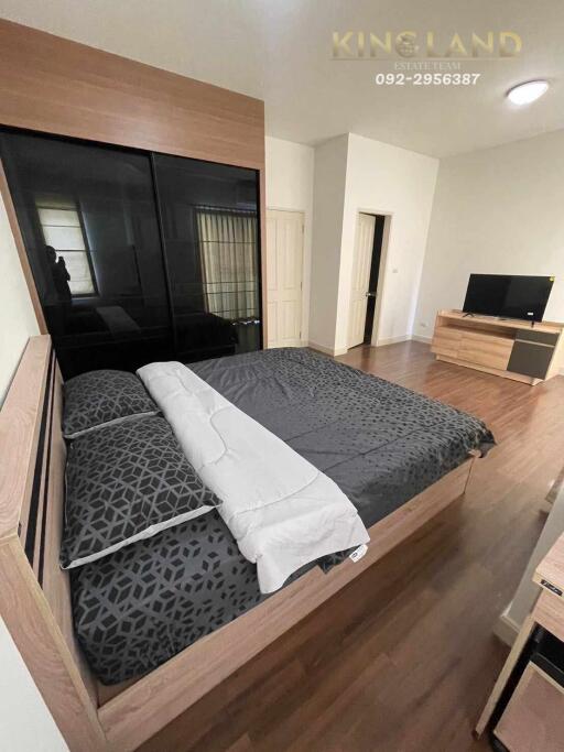 Modern bedroom with bed and TV unit