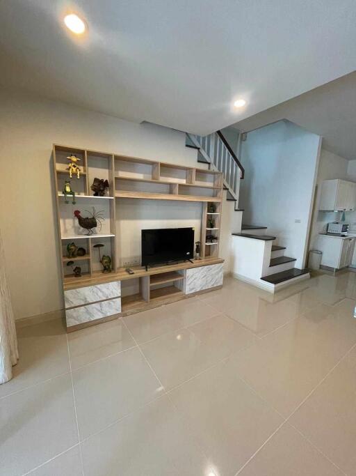 Modern living room with TV unit and staircase