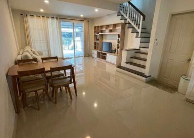 Modern living room with dining area and staircase