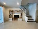 Living room with TV and staircase