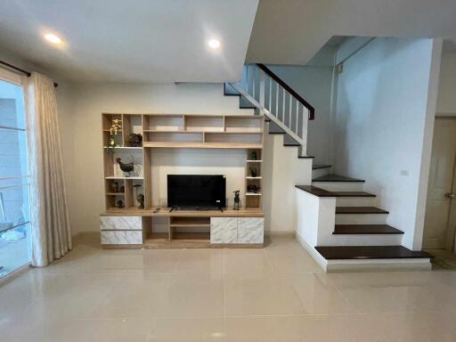 Living room with TV and staircase