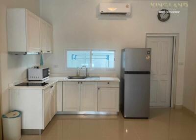 Modern kitchen with white cabinets and appliances