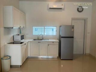 Modern kitchen with white cabinets and appliances