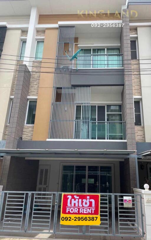 Modern three-story building with balconies and rental signage