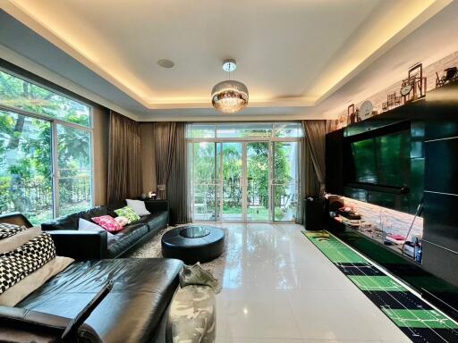 Spacious living room with large windows and garden view.