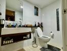 Modern bathroom with sink, toilet, mirror, and shelving