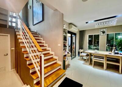 Living area with staircase and dining table