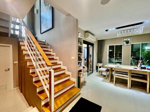 Living area with staircase and dining table