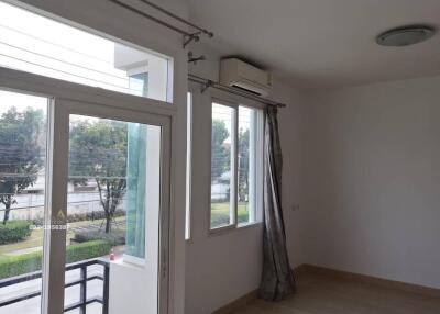 Living room with large windows and air conditioner