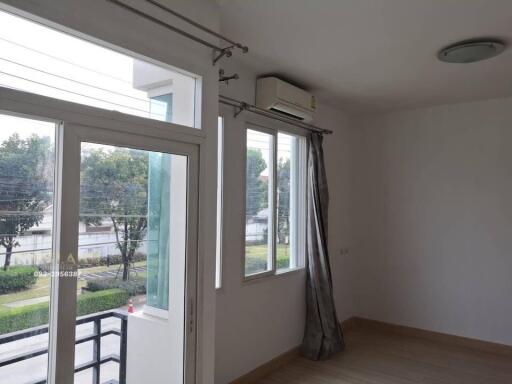 Living room with large windows and air conditioner