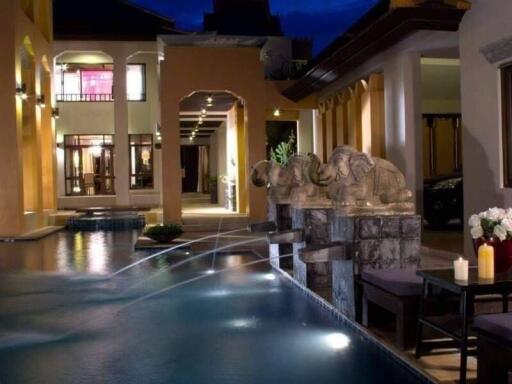 Luxurious outdoor space with pool and decorative fountains