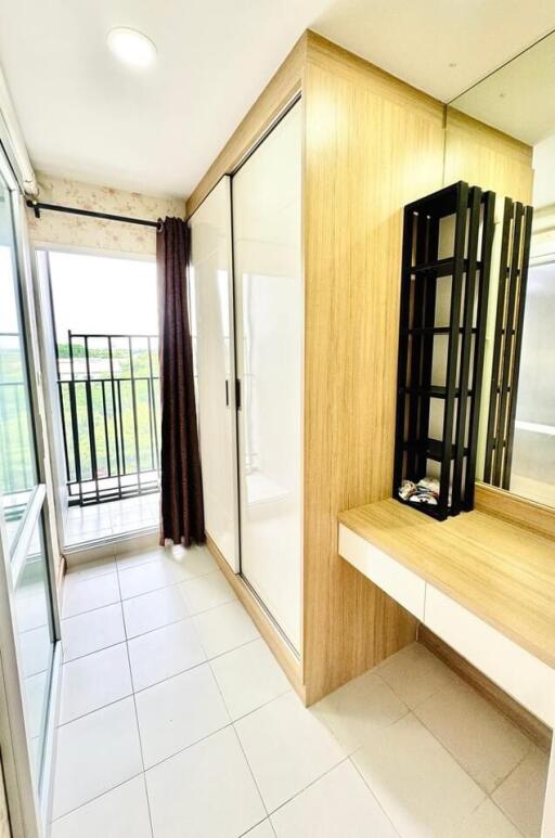 Spacious bedroom with balcony access, built-in wardrobe, and vanity area