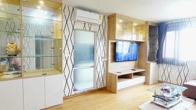 Modern living room with built-in glass cabinets, TV, and air conditioning