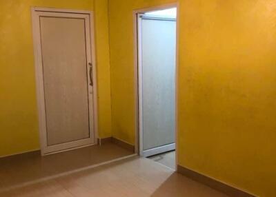 Room with yellow walls and light wooden floor