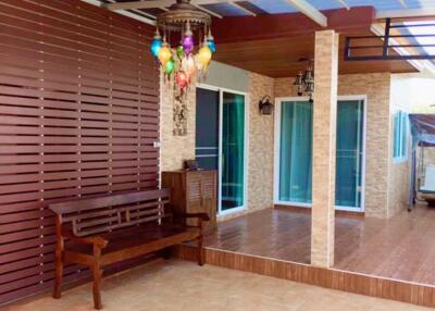 Covered Patio with Bench and Colored Lantern