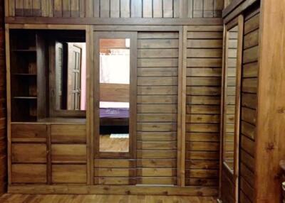 Wooden bedroom with built-in closets and shelves